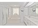 Bright main bathroom with a soaking tub, glass-enclosed shower, and double vanity at 8300 Parkside Dr, Englewood, FL 34224