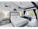 Serene main bedroom with a tufted headboard, and a sliding glass door with backyard view at 8300 Parkside Dr, Englewood, FL 34224