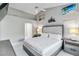 Well-lit main bedroom with a tufted headboard, ample space, and clean décor at 8300 Parkside Dr, Englewood, FL 34224