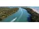 Scenic aerial view of a waterway with boats, mangroves, and sandy beach at 8300 Parkside Dr, Englewood, FL 34224