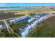 A high-angle aerial view of colorful condominium buildings nestled next to serene lake and waterfront at 8405 Placida Rd # 206, Placida, FL 33946