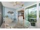 Relaxing screened balcony features a glass table and seating with views, perfect for outdoor enjoyment at 8405 Placida Rd # 206, Placida, FL 33946