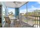 Inviting screened balcony with comfortable seating offers stunning views of the community pond and surrounding landscape at 8405 Placida Rd # 206, Placida, FL 33946