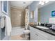 Well lit bathroom featuring a tub with tile surround and granite vanity top at 8405 Placida Rd # 206, Placida, FL 33946