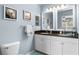 Bright bathroom with a double sink vanity and coastal artwork at 8405 Placida Rd # 206, Placida, FL 33946