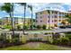 Beautiful Cape Haze resort entrance with palm trees and colorful buildings on a sunny day at 8405 Placida Rd # 206, Placida, FL 33946