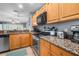 Well-equipped kitchen with granite countertops, stainless steel appliances, and light wood cabinetry at 8405 Placida Rd # 206, Placida, FL 33946