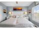 Spacious bedroom features wood floors and coastal decor and a ceiling fan at 8405 Placida Rd # 206, Placida, FL 33946