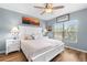 Inviting bedroom with natural light, wood flooring, and ceiling fan at 8405 Placida Rd # 206, Placida, FL 33946