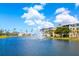 Beautiful water view in a community setting with a fountain, green space, and colorful buildings on a partly cloudy day at 8405 Placida Rd # 206, Placida, FL 33946