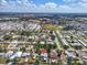 Aerial view showcasing a residential area, highlighted with houses and a sunny sky at 938 The Rialto, Venice, FL 34285