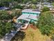Aerial view of the home with lush landscaping, mature trees, and a private driveway at 938 The Rialto, Venice, FL 34285