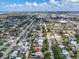 Residential houses spread across the neighborhood, highlighted by a partly cloudy sky at 938 The Rialto, Venice, FL 34285