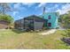 Large backyard featuring a screened-in pool, shed, and mature landscaping, perfect for outdoor enjoyment at 938 The Rialto, Venice, FL 34285