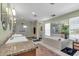 Modern bathroom featuring a walk-in shower, soaking tub, dual vanity, and bright lighting at 938 The Rialto, Venice, FL 34285
