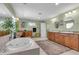Beautiful bathroom with tub, dual vanity, framed mirrors, and natural light at 938 The Rialto, Venice, FL 34285
