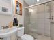 Modern bathroom showcasing a glass-enclosed shower and a pedestal sink at 938 The Rialto, Venice, FL 34285