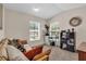 Bedroom showcasing neutral walls, carpet, ample light, with sofa seating for an ideal relaxation area at 938 The Rialto, Venice, FL 34285