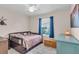 Cozy bedroom featuring a ceiling fan, bright window, and charming decor at 938 The Rialto, Venice, FL 34285