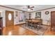 Dining room featuring hardwood floors, a large window, and a wooden dining table with seating for six at 938 The Rialto, Venice, FL 34285