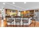 Spacious kitchen featuring a breakfast bar with dark granite countertops, bar stool seating and stainless steel appliances at 938 The Rialto, Venice, FL 34285