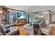 Comfortable living room with a large window view of the backyard, a ceiling fan and hardwood flooring at 938 The Rialto, Venice, FL 34285
