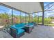 Inviting outdoor patio featuring comfortable seating and dining area, enclosed for year-round enjoyment at 938 The Rialto, Venice, FL 34285