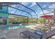 Beautiful screened-in pool area with lounge chairs and dining set, perfect for relaxing or entertaining guests at 938 The Rialto, Venice, FL 34285