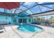 Relaxing screened-in pool with a paver deck, offering a private backyard oasis for year-round enjoyment at 938 The Rialto, Venice, FL 34285