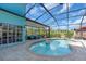 Backyard pool with screened enclosure and seating areas for outdoor enjoyment at 938 The Rialto, Venice, FL 34285