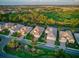 Birds-eye view of a home showcasing its red tile roof, manicured lawn, and proximity to the community at 27336 Driver Ln, Englewood, FL 34223
