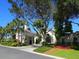 Elegant clubhouse with a porte cochere, arched window, beautiful landscaping and a meticulously kept lawn at 27336 Driver Ln, Englewood, FL 34223