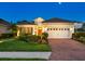 Beautiful single-story house featuring a red tile roof, brick paver driveway, and a two-car garage at 27336 Driver Ln, Englewood, FL 34223