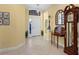 Inviting foyer with tiled floor, arched transom window above door, and a traditional grandfather clock at 27336 Driver Ln, Englewood, FL 34223
