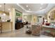 Open-concept living space featuring tile floors, a neutral color scheme, and access to dining area at 27336 Driver Ln, Englewood, FL 34223