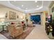 Open living room with elegant tile flooring, neutral tones, and access to the outdoor patio at 27336 Driver Ln, Englewood, FL 34223