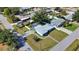 Aerial view showcasing the home's backyard with a screened-in pool and manicured lawn at 100 Aurora W St, Venice, FL 34285