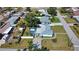 This aerial showcases a lovely property with screened pool, backyard, and well-kept lawn in a suburban neighborhood at 100 Aurora W St, Venice, FL 34285