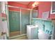 Colorful bathroom with a glass enclosed shower, vanity, and decorative mirror at 100 Aurora W St, Venice, FL 34285
