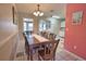 Open dining area with a large wood table, seating eight, and tiled floors at 100 Aurora W St, Venice, FL 34285
