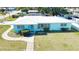Charming single-story home with a well-maintained lawn, concrete walkway, and a light blue exterior at 100 Aurora W St, Venice, FL 34285