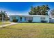 Lovely light blue single-story home with a well-manicured lawn and neat landscaping at 100 Aurora W St, Venice, FL 34285