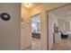 Hallway leading to a bedroom with tiled floors and neutral walls at 100 Aurora W St, Venice, FL 34285