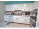 Classic kitchen featuring white cabinetry, appliances, and neutral countertops at 100 Aurora W St, Venice, FL 34285
