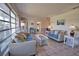 Inviting living room with tiled floors, lots of natural light, and cozy seating arrangements at 100 Aurora W St, Venice, FL 34285