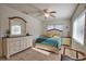 Bright main bedroom features neutral walls, tiled flooring, and a ceiling fan at 100 Aurora W St, Venice, FL 34285