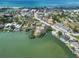 Aerial view of coastal condos with a community pool, nestled between the bay and the beach at 101 Louella Ln # 11, Nokomis, FL 34275