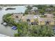 Aerial view of waterfront condos with a community pool, surrounded by lush greenery at 101 Louella Ln # 11, Nokomis, FL 34275