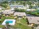 Aerial view of sunny waterfront condos with a communal pool, lush lawns and colorful boats at 101 Louella Ln # 11, Nokomis, FL 34275