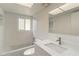 Bright white bathroom featuring subway tiles, a bathtub, and a modern vanity at 101 Louella Ln # 11, Nokomis, FL 34275
